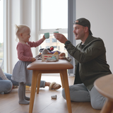 Nordic Bench in oak with Terra Black leather seat and solid wood frame in a simple setting