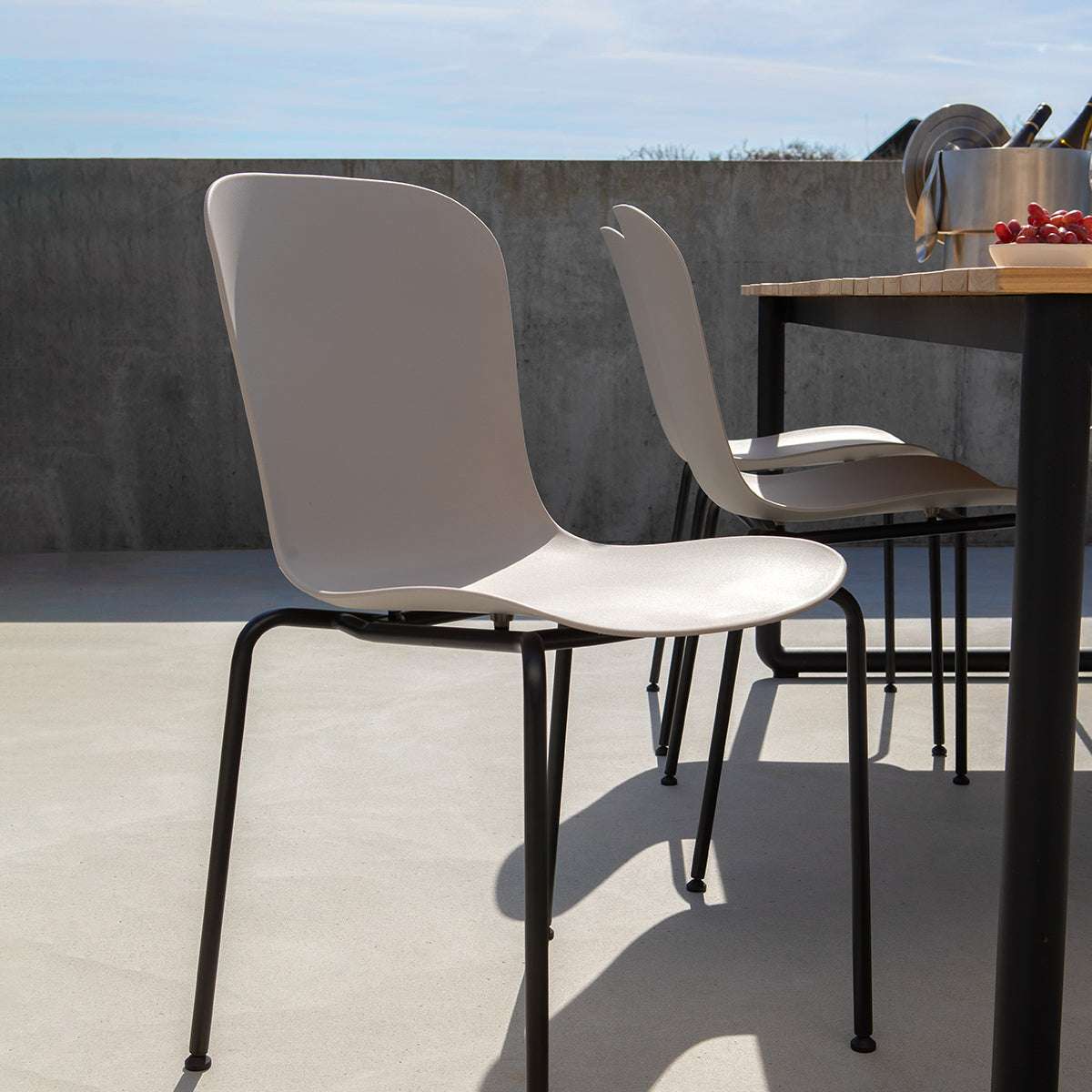 Taupe Patio Chair no. One with black powder-coated steel frame for outdoor use.