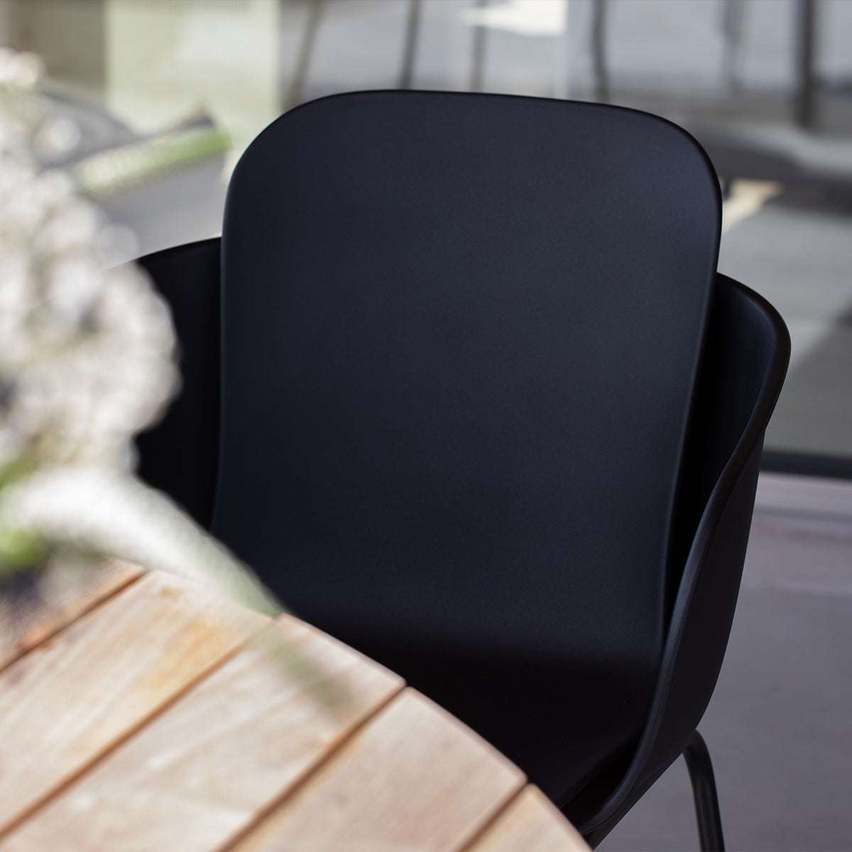 Taupe and black Patio Chair no. One S2 with two-shell design and black powder-coated steel frame outdoors