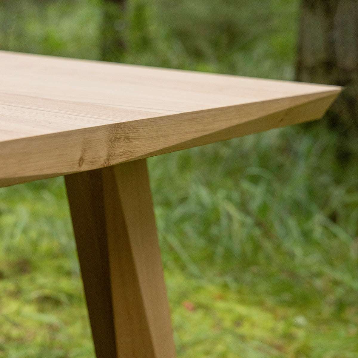 Edge Dining Table made of European oak with detailed facets in a bright indoor setting