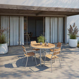 Round taupe Kirra Dining Table with teak wood top and powder-coated aluminum frame outdoors