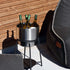 Black powder-coated stainless steel patio accessory stand with a stainless steel wine bucket and accessories on a wooden deck.