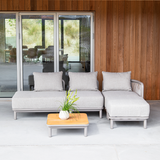 Kirra Lounge Sofa in Kirra Sand with open end right, powder-coated aluminum frame and olefin textile cushions outdoors