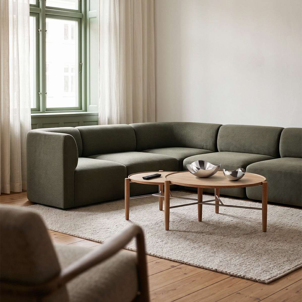 sackit Fjord corner sofa in soft olive fabric styled in a bright Scandinavian living room with a wooden coffee table and neutral rug