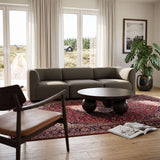 sackit europe Fjord three seater sofa with soft curves in a calm Scandinavian living room beside a round coffee table and patterned rug