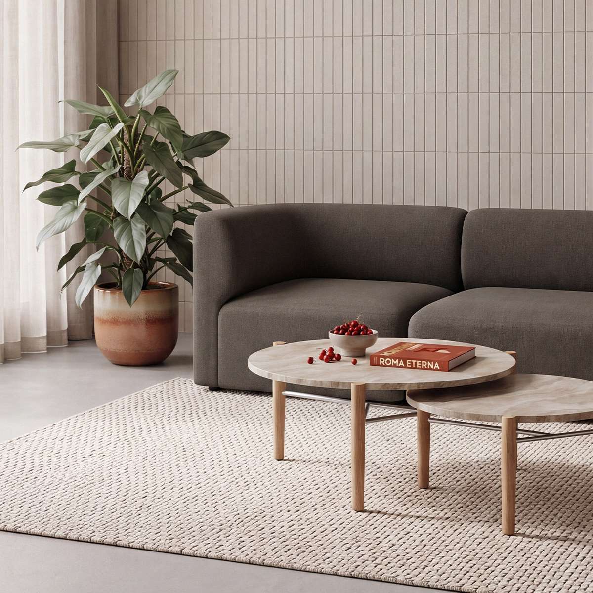 sackit Fjord two seater sofa in dark brown with round wood coffee tables and a leafy plant in a calm Scandinavian living room