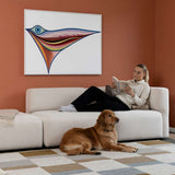 sackit Fjord two seat sofa with open end in a calm Scandinavian interior where a woman reads and a dog rests on the soft light upholstery