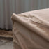 Close view of a sand colored weather resistant cover fitted over a Cobana Lounge Sofa corner module by sackit for outdoor protection