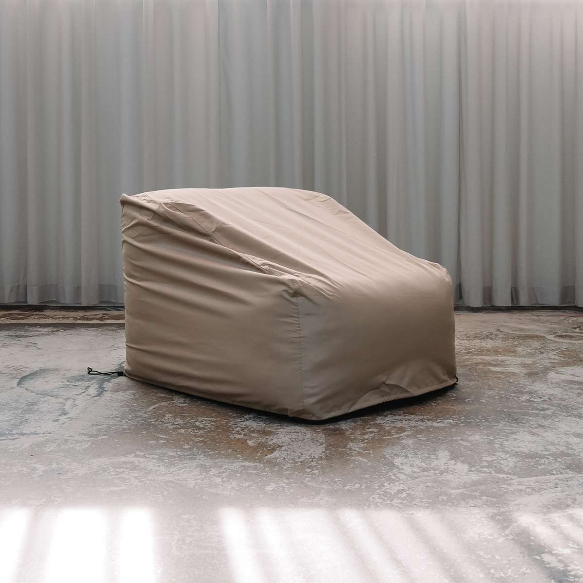Sand colored water repellent cover fitted over a Soft Sofa outdoor seat for protection from wind and weather by sackit