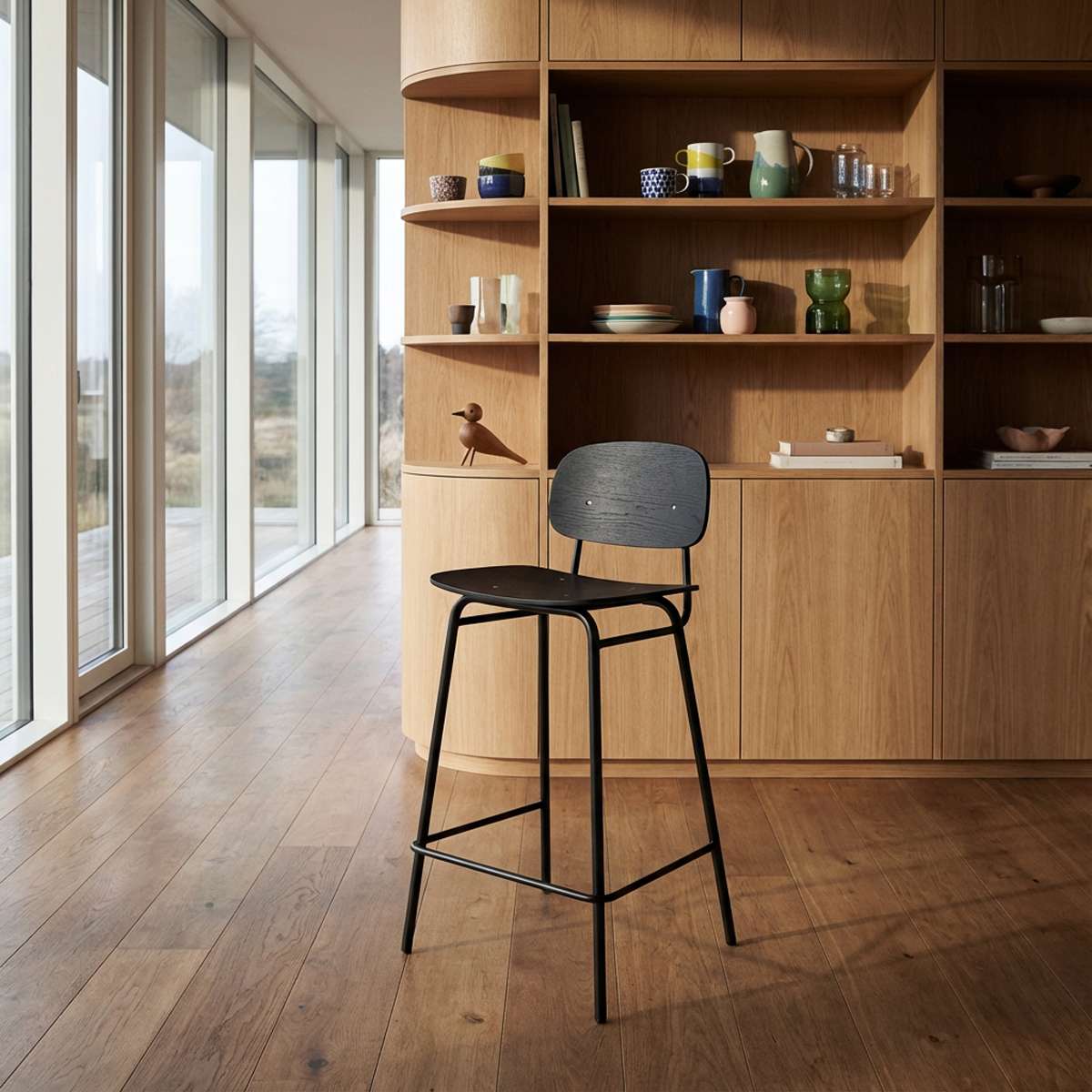 High bar stool with black stained oak seat and powder-coated steel frame with backrest and footrest.