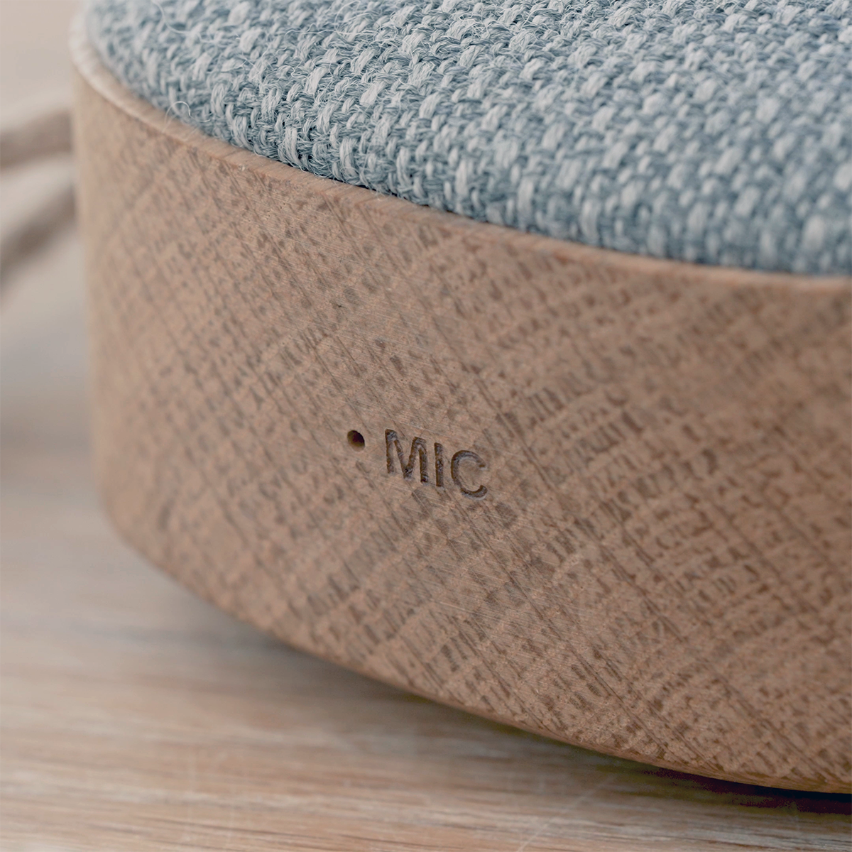 Portable Go Wood speaker with smoked oak frame and Fiord textile, shown in a lifestyle setting.