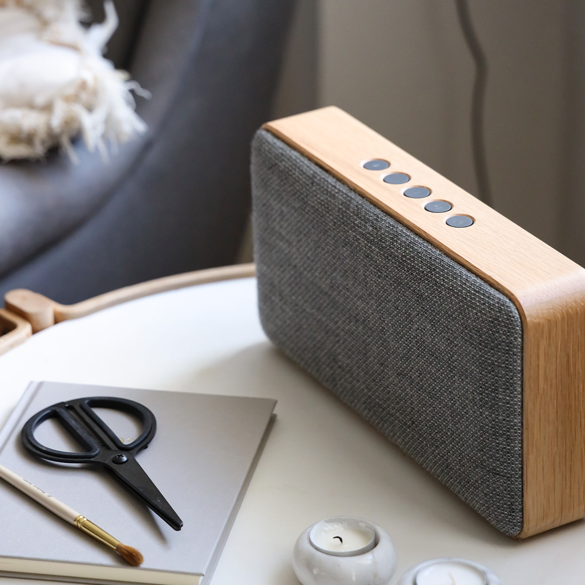 Bluetooth speaker with natural oak wood and Fiord textile from KVADRAT, showing a sleek rectangular design.