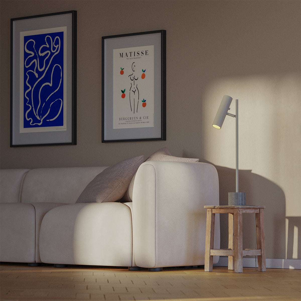 Grey aluminum table lamp with marble base and warm lighting on a white background.