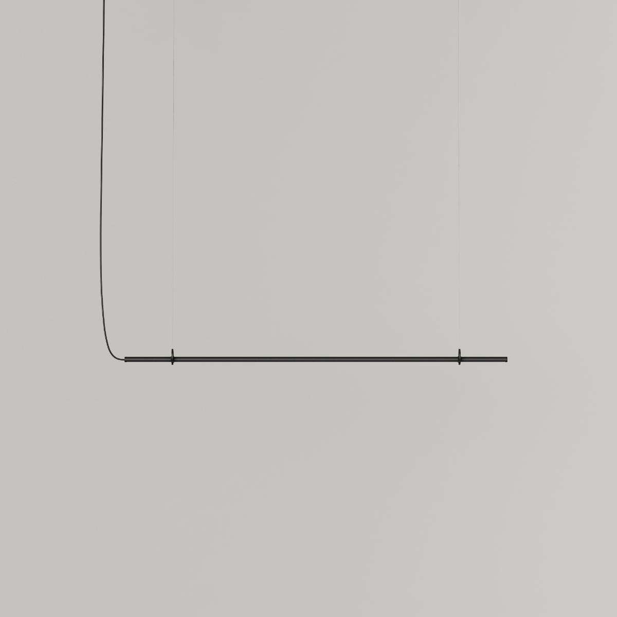 Ease 120 pendant lamp for the dining table in Black by sackit switched on, casting warm light