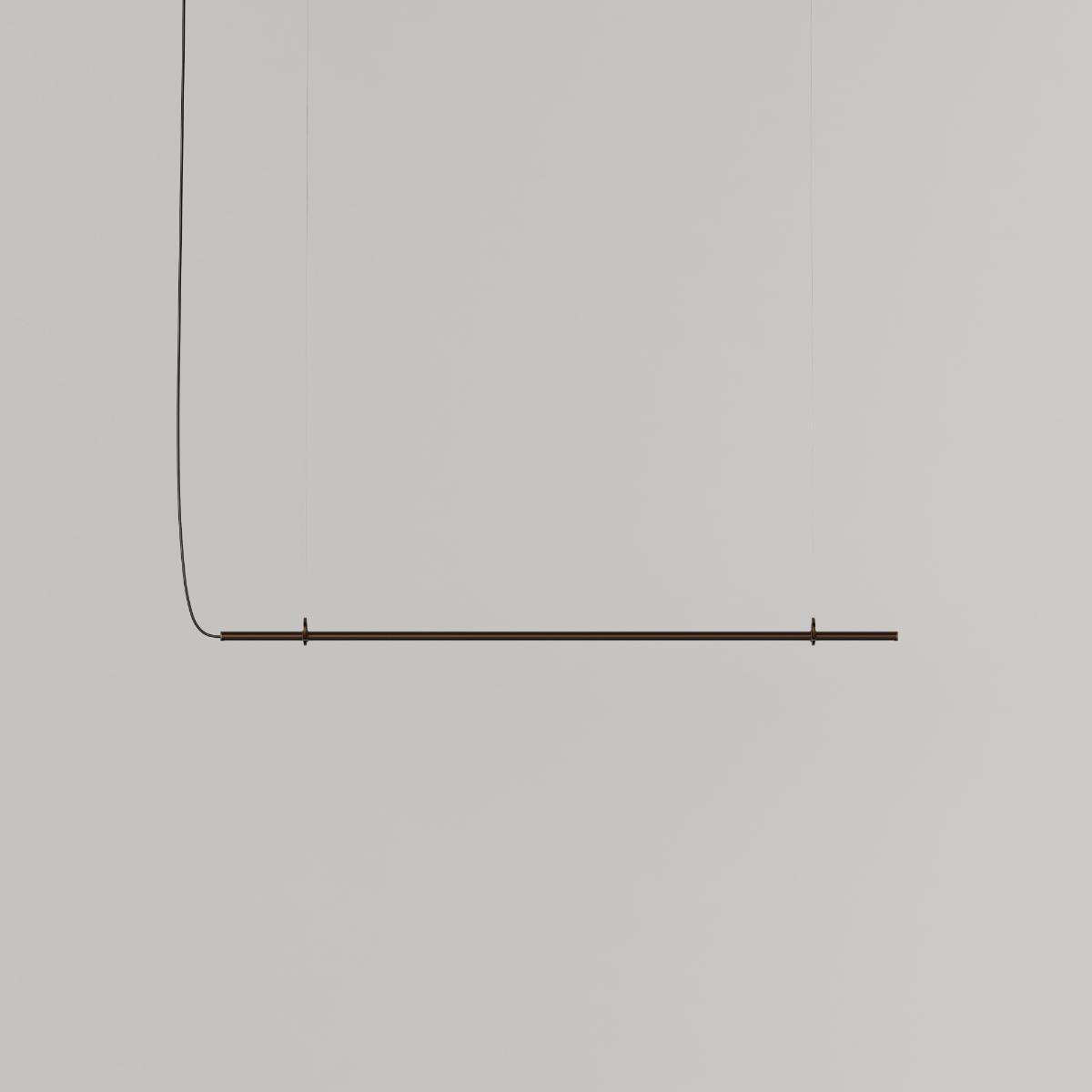 Ease 120 pendant lamp for the dining table in Bronze by sackit switched on, casting warm light