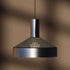 Polished aluminum Dawn Pendant Ø25 with perforated top and white inner shade hanging indoors