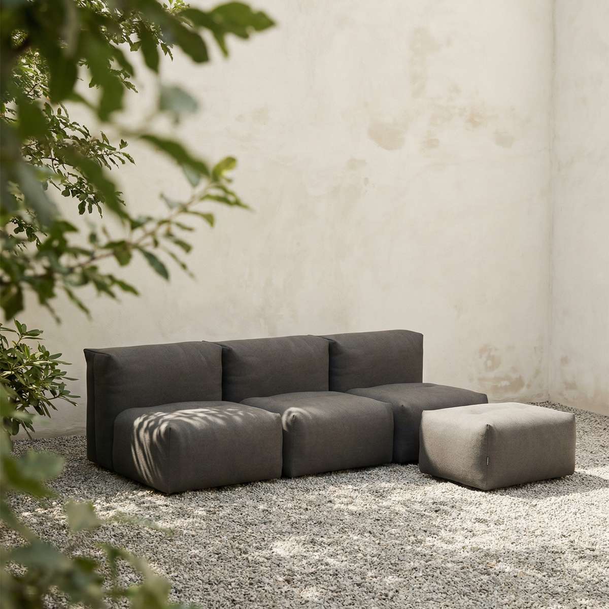 Soft Sofa Outdoor 3-seater in Kirra Olive with pouf, soft fabric, low backrest, outdoor setting.