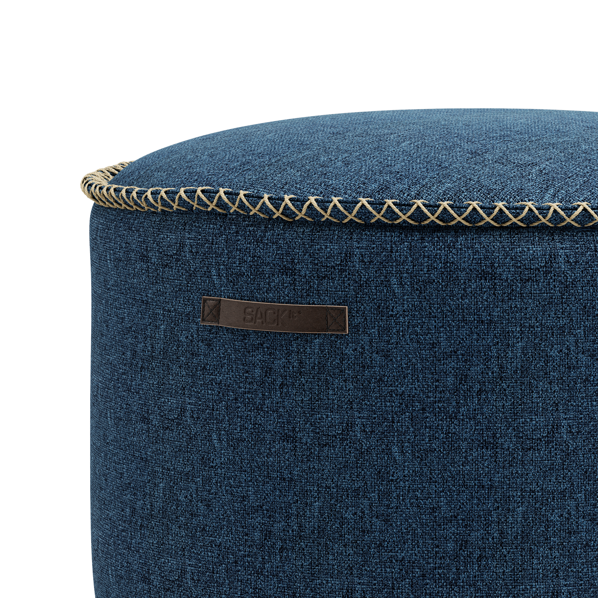 Round Medley Pouf in denim blue fabric with soft texture and hand-sewn linen stitches.