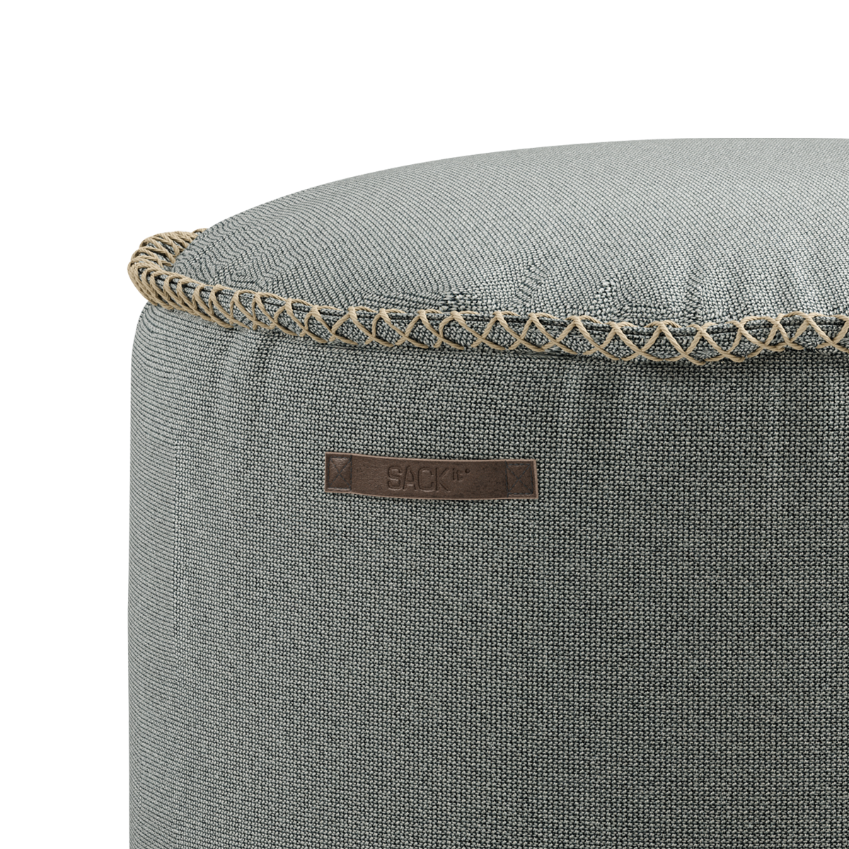 Round Cura Pouf in dark blue Cura fabric with hand-sewn stitches on a white background.