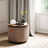 Warm beige canvas pouf with a rounded shape beside a sunlit window in a refined Nordic interior by sackit