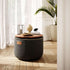 Black canvas pouf with a wooden tray top in a bright Nordic interior from sackit
