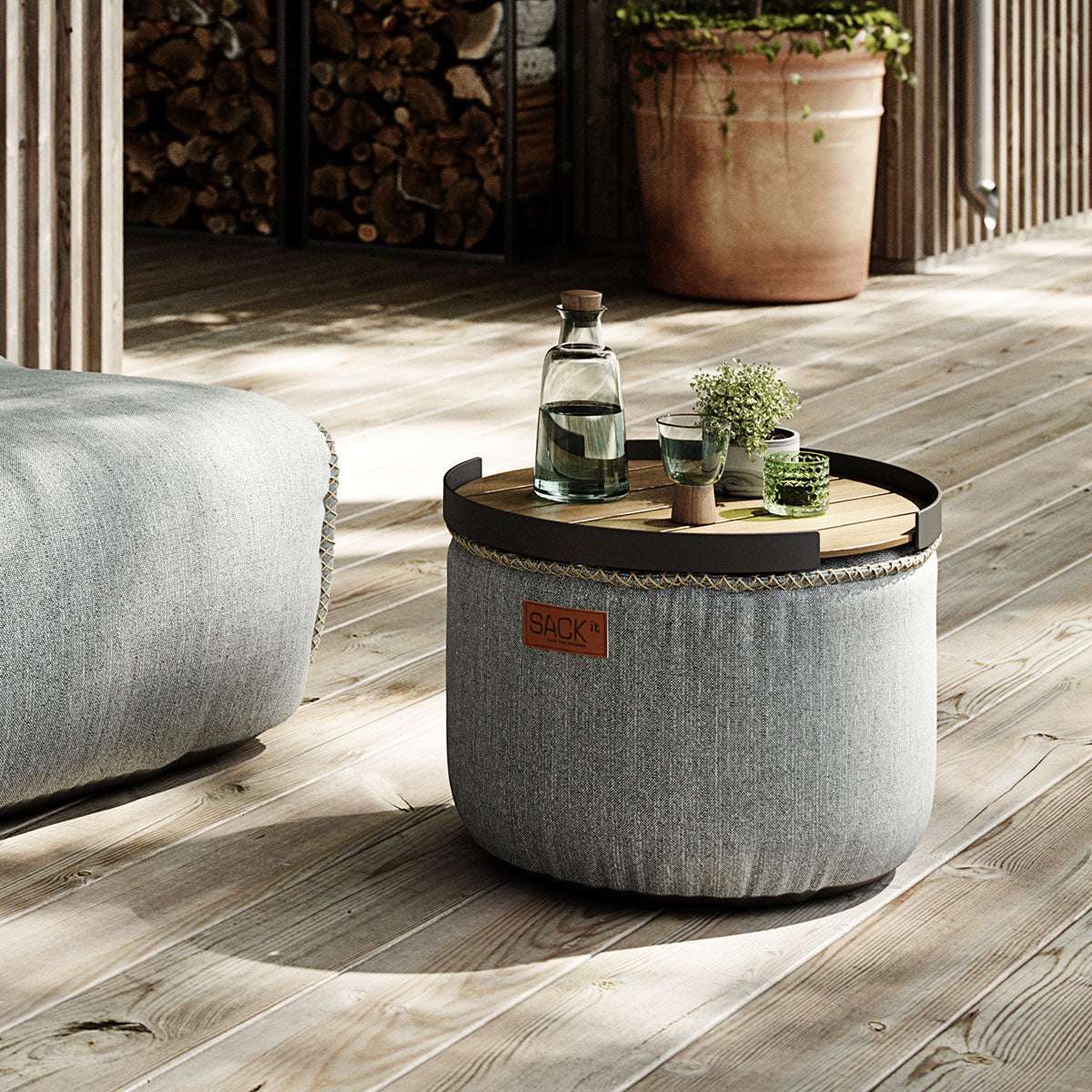Round Cobana Grey pouf with textured fabric and hand-sewn stitches for indoor and outdoor use