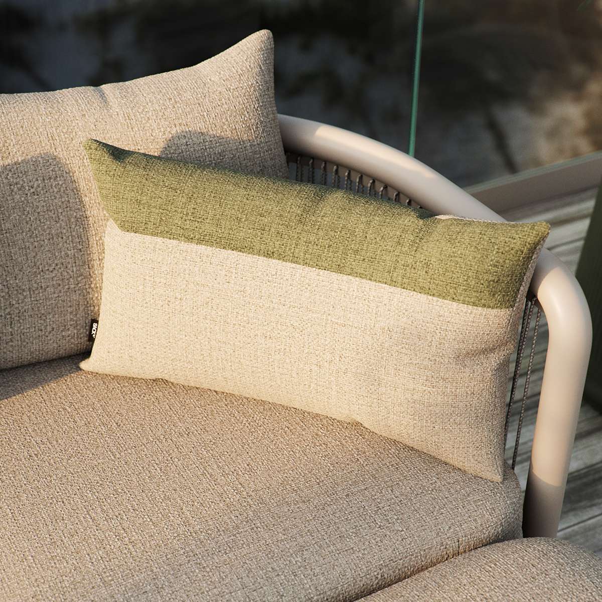 Tide Cushion in sand and indigo color blocks on outdoor lounge furniture.