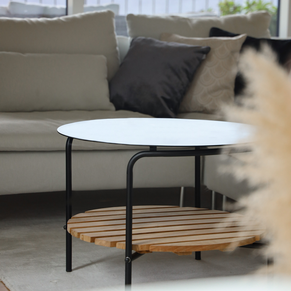 Square outdoor patio sofa table with black powder-coated aluminum frame and teak wood shelf underneath