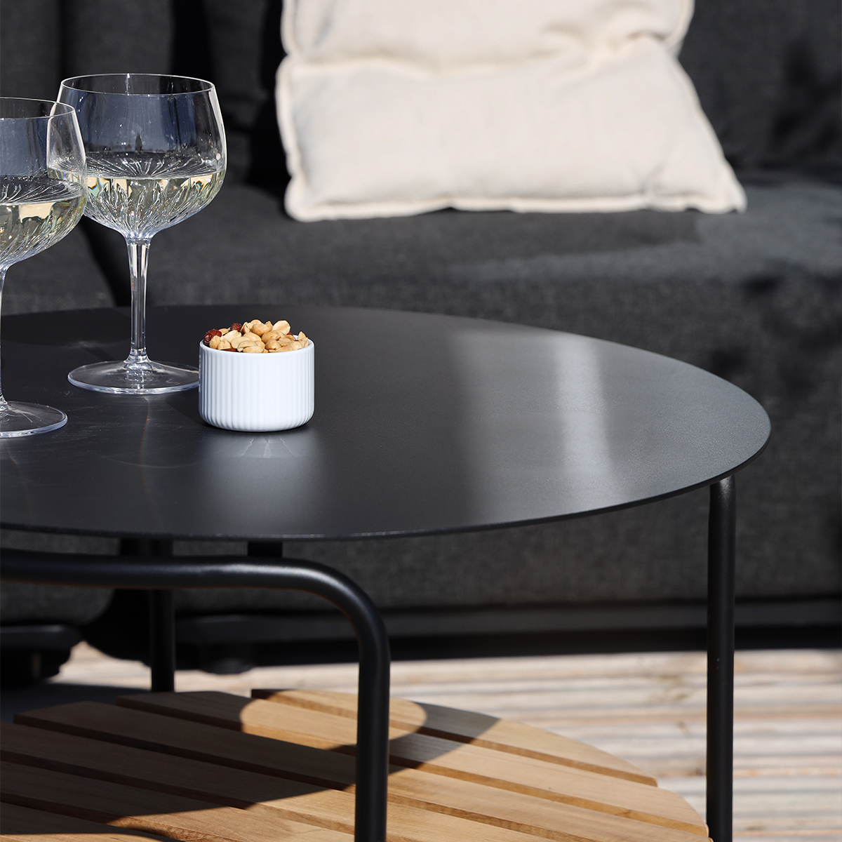 Square outdoor patio sofa table with black powder-coated aluminum frame and teak wood shelf underneath