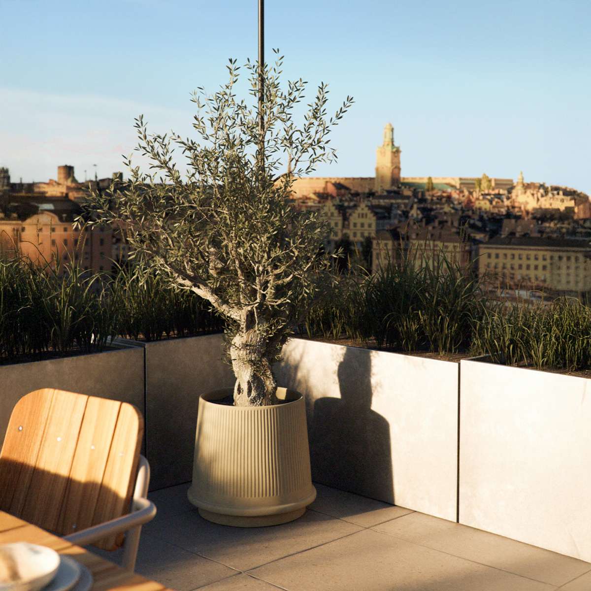 Sand-colored Gaia 38 ceramic outdoor planter with fluted surface and drainage hole