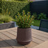 Mocca-colored ceramic Gaia 16 outdoor planter with fluted matte surface and drainage hole