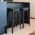 Nordic Bar Stool in black stained oak with Terra Black leather upholstery and visible stitching detail.