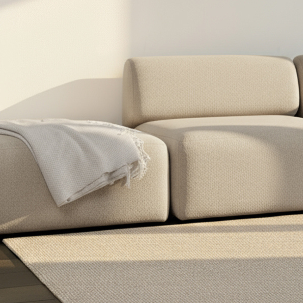 Cosmo Beige Fjord Sofa pouf with soft rounded edges and textured upholstery in a bright setting