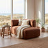 Brown Fjord sofa with right chaise lounge and soft cushions in a bright Scandinavian living room overlooking coastal dunes by sackit