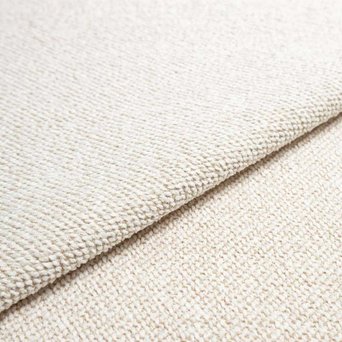 Close up of soft cream textured upholstery fabric from the Fjord Sofa corner sofa by sackit for a calm Scandinavian interior