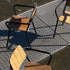 Kirra Patio Chair with powder-coated aluminum frame and teak wood seat in outdoor setting