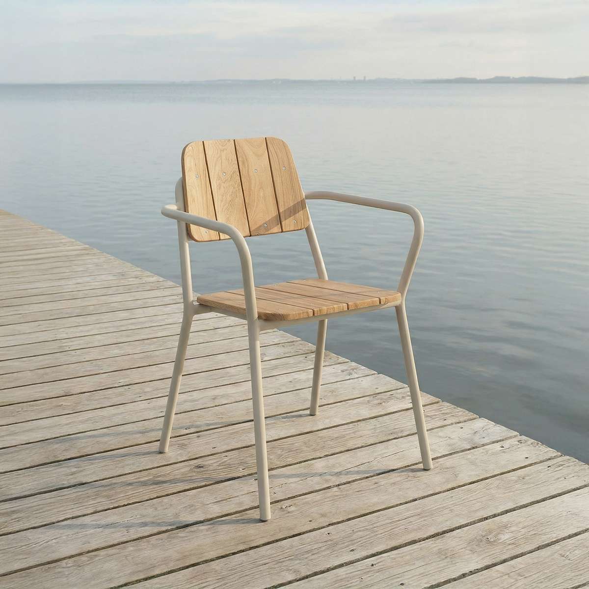 Taupe Kirra Patio Chair made of powder-coated aluminum and teak wood shown outdoors