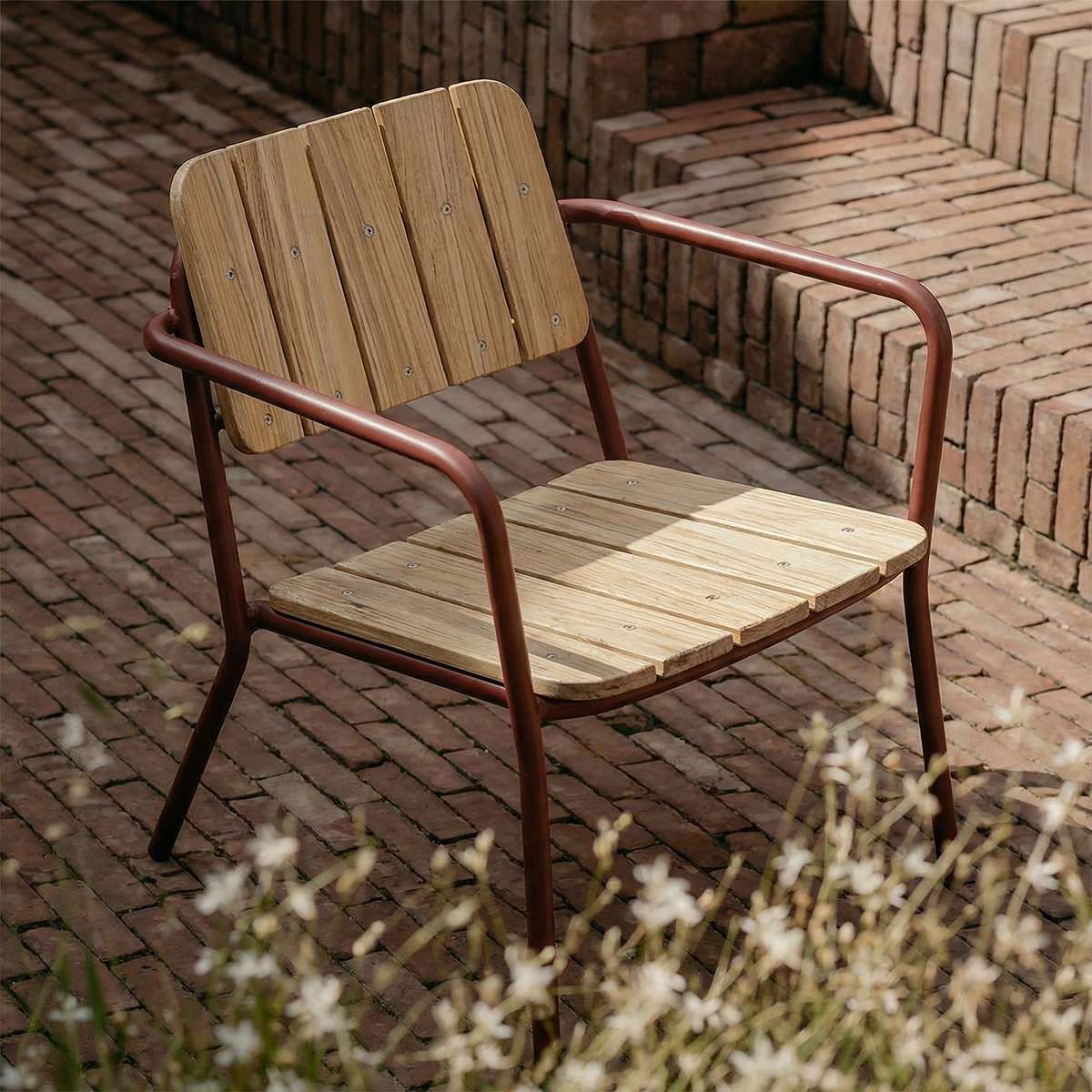 Kirra Patio Lounge Chair in chestnut with powder-coated aluminum frame and teak wood seat outdoors