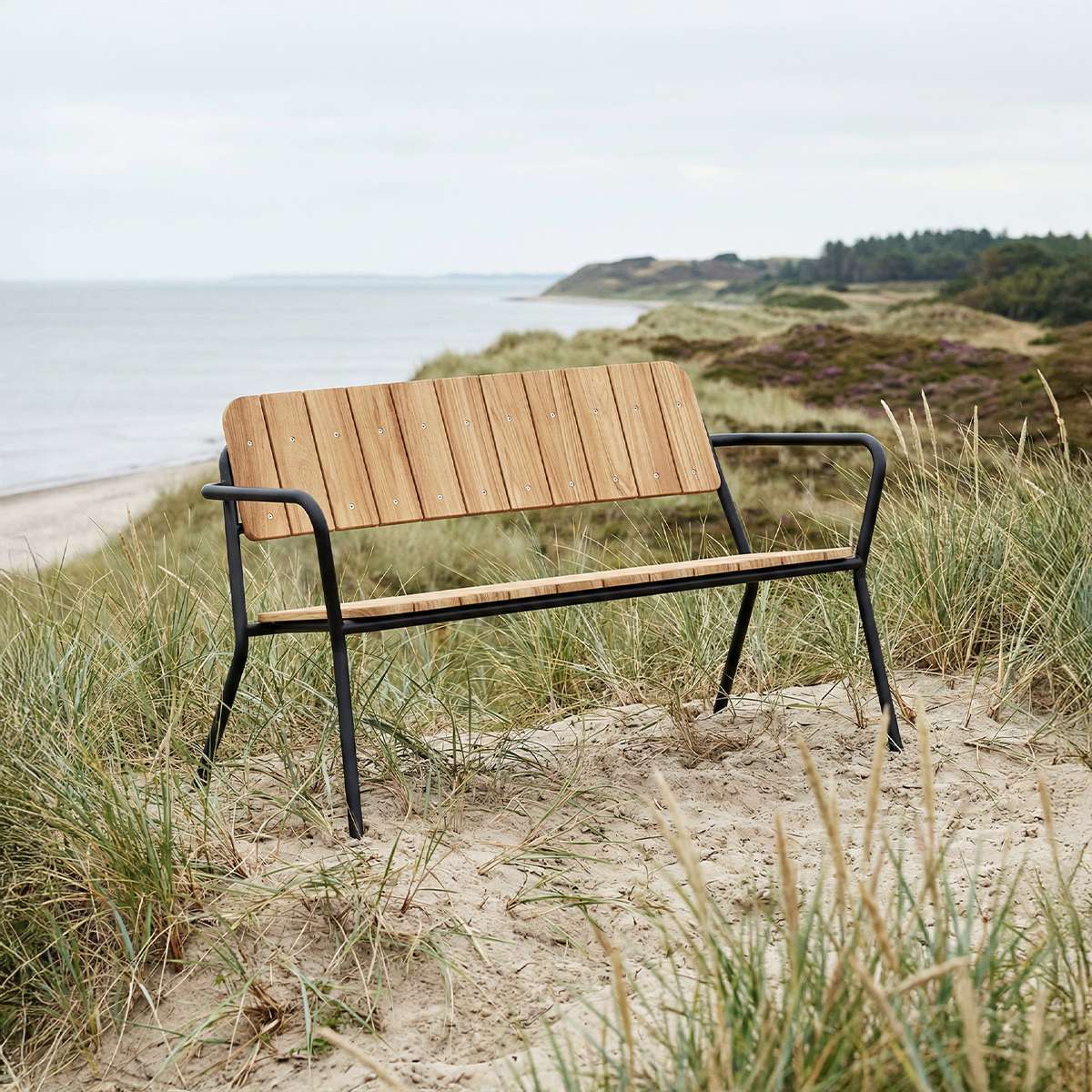 Kirra Patio Bench in Noir with powder-coated aluminum frame and teak wood seat outdoors
