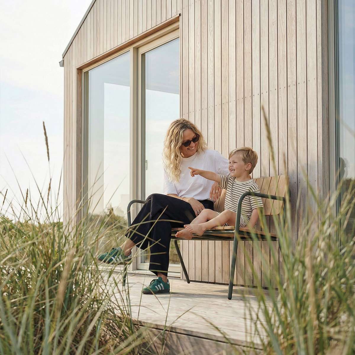 Olive Kirra Patio Bench with powder-coated aluminum frame and teak wood seat outdoors