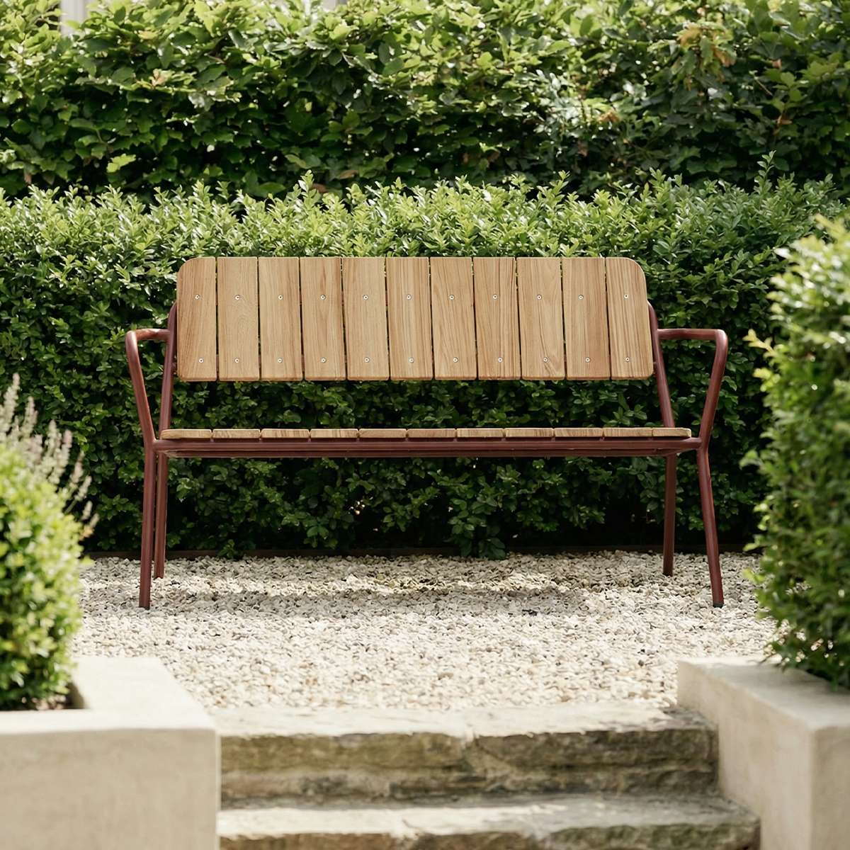 Chestnut Kirra Patio Bench with powder-coated aluminum frame and teak wood seat in outdoor setting