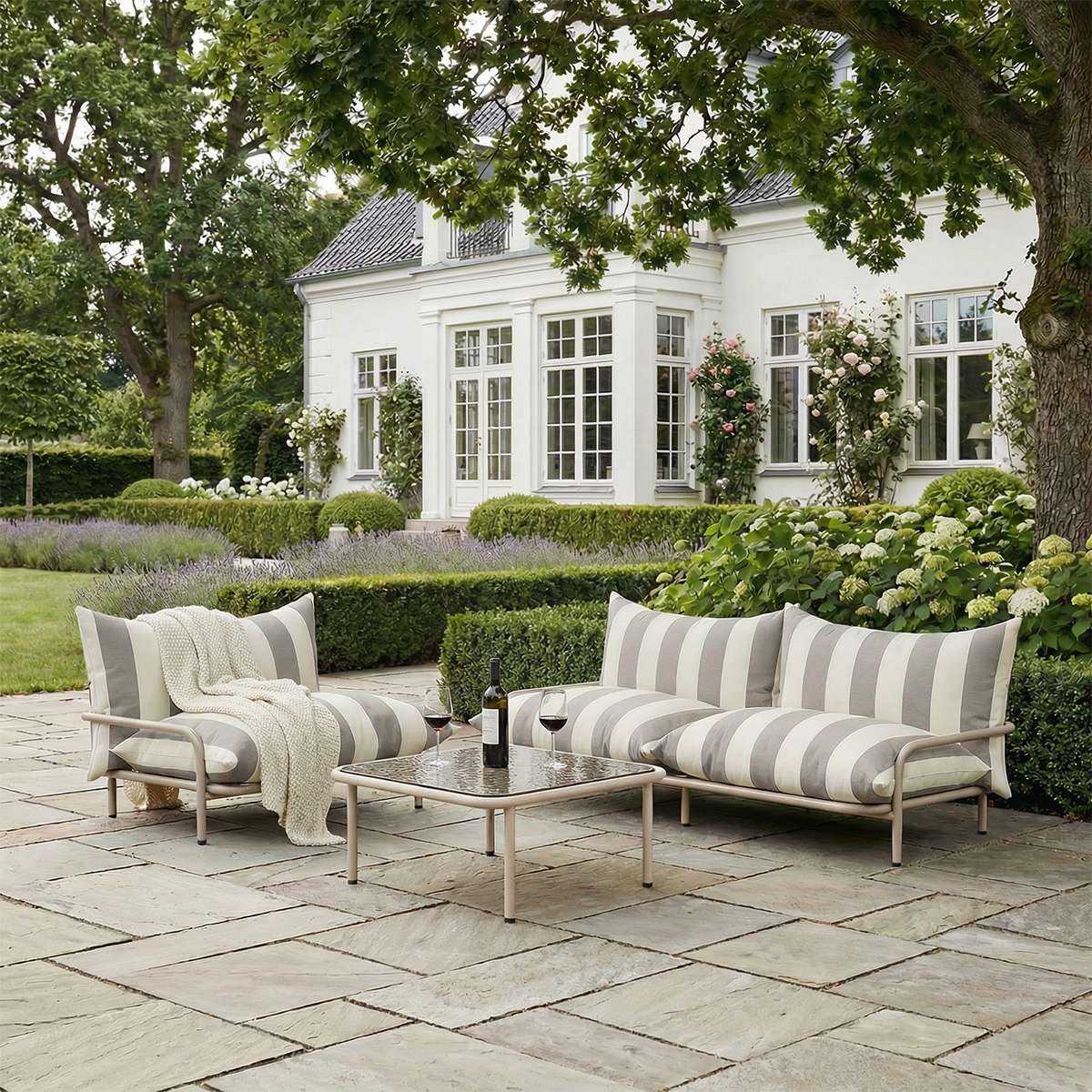 Square Mollis Coffee Table in taupe with powder-coated aluminum frame and smoked tempered glass top outdoors.