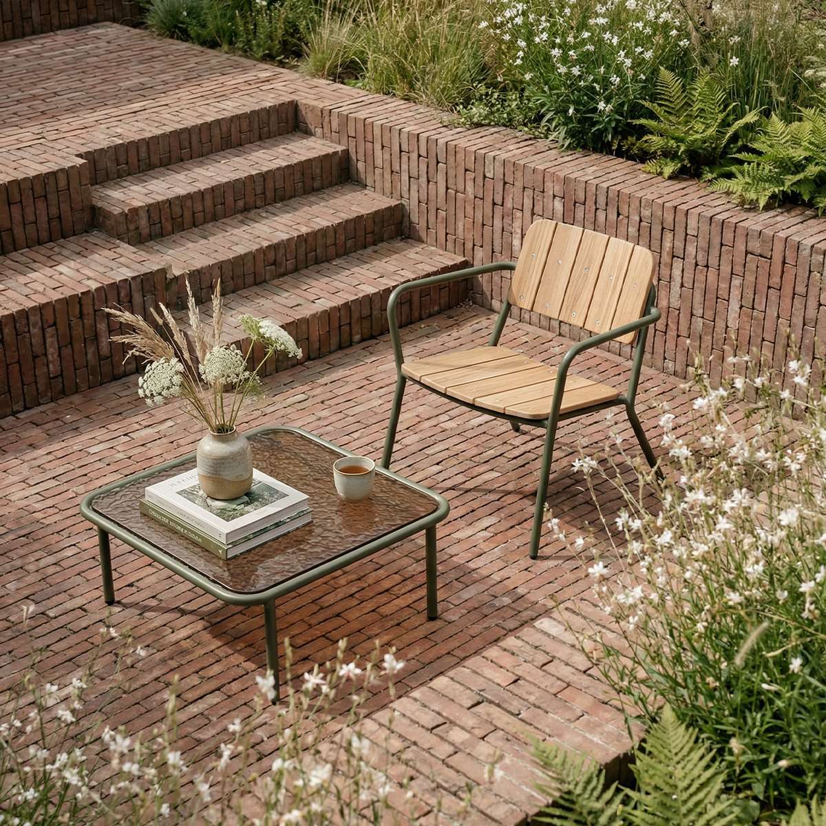 Square Mollis Coffee Table with olive powder-coated aluminum frame and smoked tempered glass top outdoors.