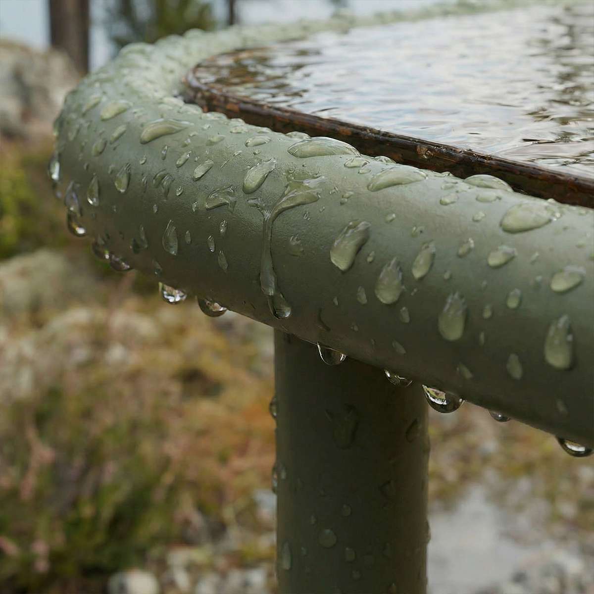 Olive Mollis Coffee Table with square smoked tempered glass top and powder-coated aluminum frame outdoors