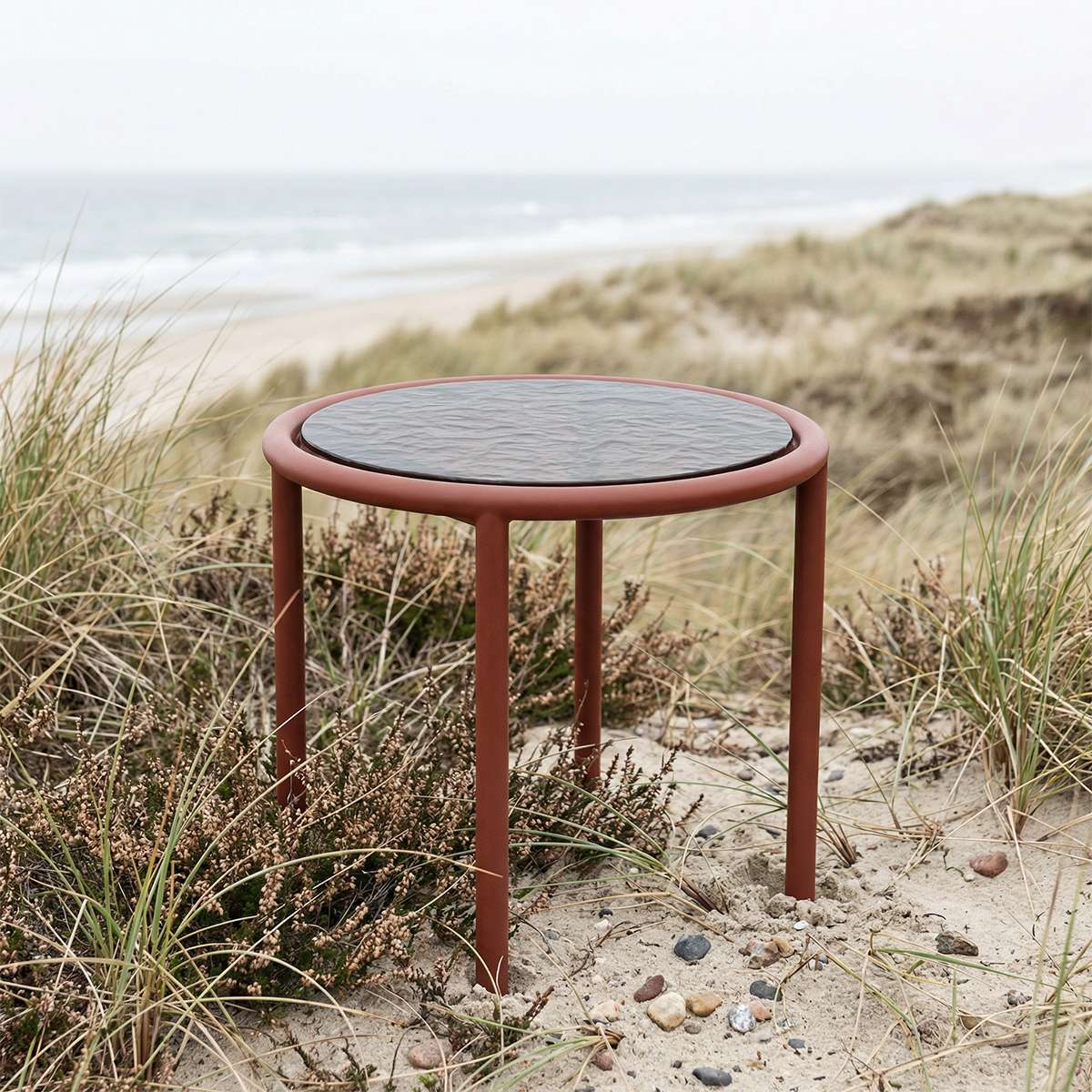 Chestnut Mollis Side Table Ø50 with powder-coated aluminum frame and smoked tempered glass top outdoors.