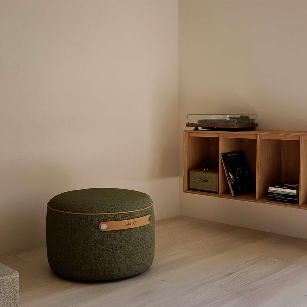 SACKit Pouf Indoor in corduroy olive fabric with a round shape and side handle on a light floor.