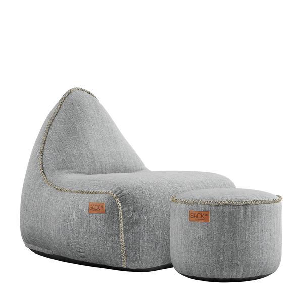 Cobana Lounge Chair and Pouf in Cobana Sand Melange fabric with soft rounded shapes and textured finish