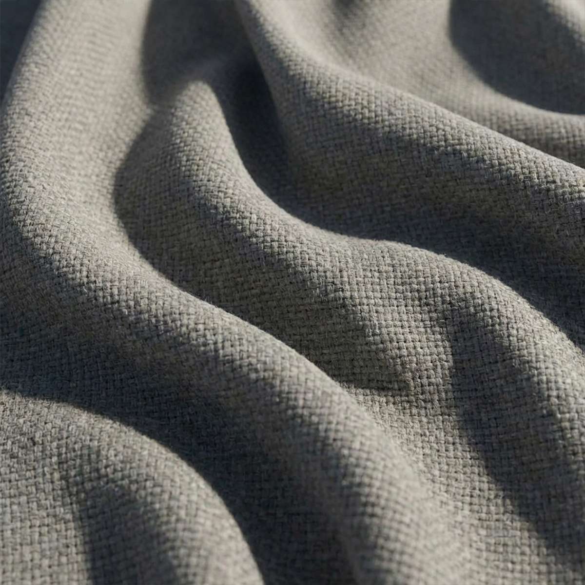 Close up of textured grey outdoor upholstery fabric with a durable woven surface from sackit